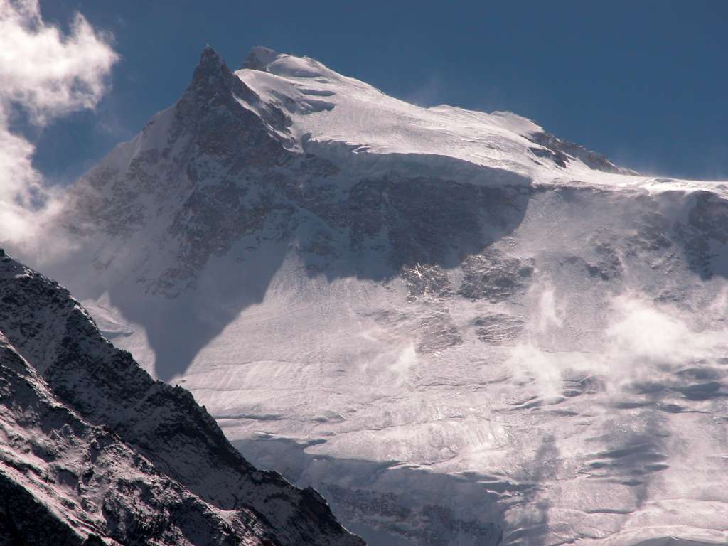 Manaslu 08 07 Manaslu From Just Before Larkya Phedi A half hour before Larkya Phedi, through a break in the mountains caused by Larkya Glacier, I had a sensational view of the full width of the north face of Manaslu from the East Pinnacle to the Main Summit. The normal route of ascent goes to the right and then crosses the large plateau to the summit.